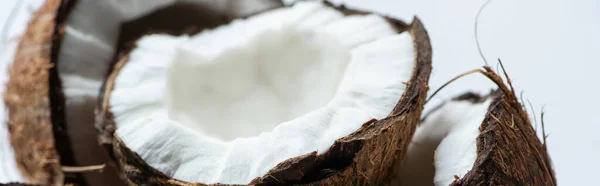 Close up view of tasty coconut halves on white background, panoramic shot — Stock Photo