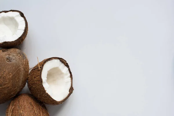 Draufsicht auf frische leckere geknackte Kokosnüsse auf weißem Hintergrund — Stockfoto