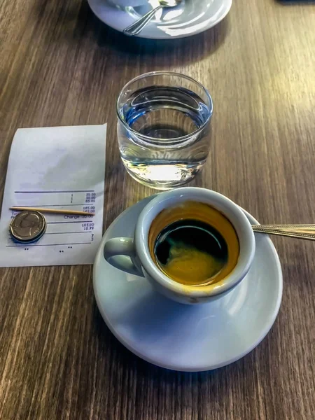 A cup of coffee next to a pair of glasses photo – Free Italy Image