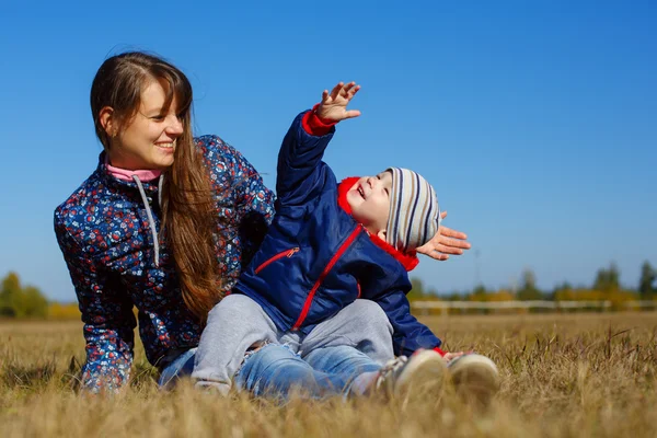 Happy young beautiful mather with baby on nature outdoor — Stok Foto