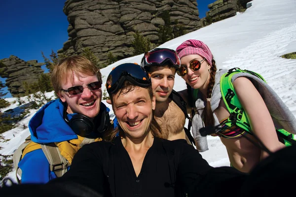 Группа счастливых друзей катаются на сноуборде, делая селфи — стоковое фото