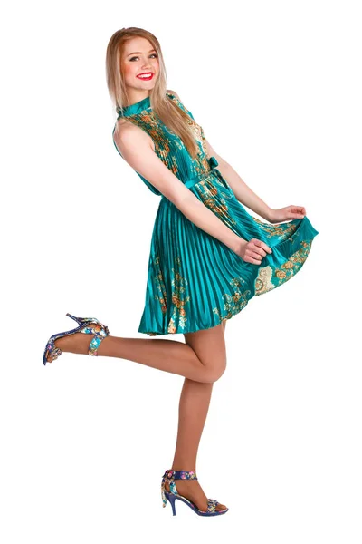Beautiful young girl in a green dress dancing. — Stock Photo, Image