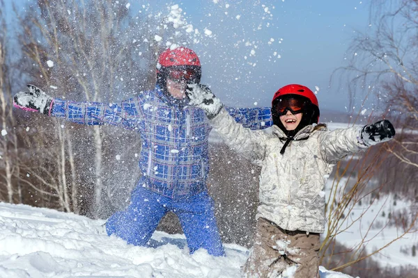 Mom and daughter, in ski equipment play with snow — Stock Photo, Image