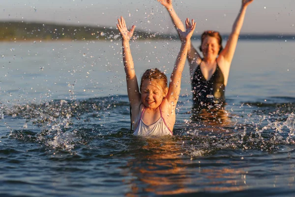 A little girl and her mother  in the water of the sea. — Stock Photo, Image