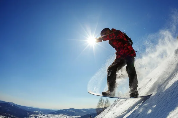 Snowboarder jumping από το εφαλτήριο ενάντια στον ουρανό — Φωτογραφία Αρχείου