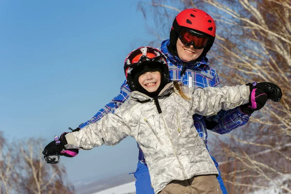 Moeder en dochter, in skiuitrusting spelen met sneeuw — Stockfoto