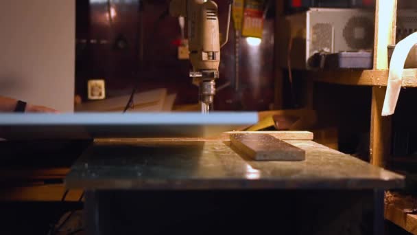 Male worker drills wood material — 비디오