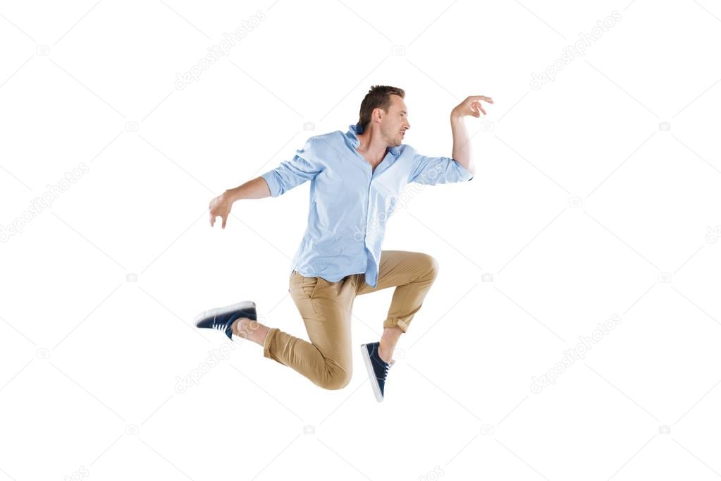 young man jumping and looking away