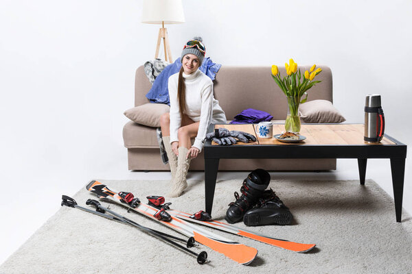 young sportswoman wearing warm socks, ski equipment near