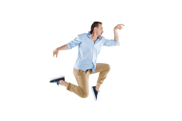 Young man jumping and looking away — Stock Photo
