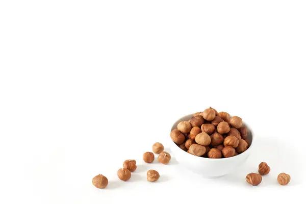 Purified hazelnuts in a bowl on a white background — Stock Photo, Image