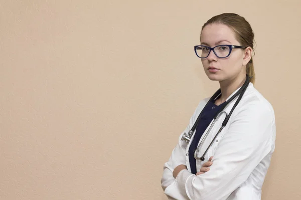 Real female doctor with the red stethoscope in medical uniform