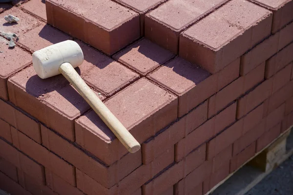 repairing the sidewalk in the city (hammer and bricks)
