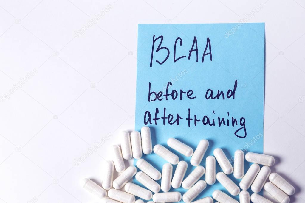 sport nutrition, supplements - bcaa in capsules and guide for it on the white background 
