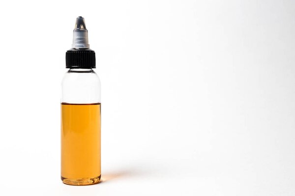 e- liquid, e-juice in the bottles isolated on the white background with copyspace