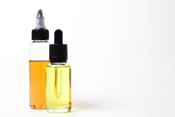 E- liquid, e-juice in the bottles isolated on the white background with copyspace — Stock Photo, Image