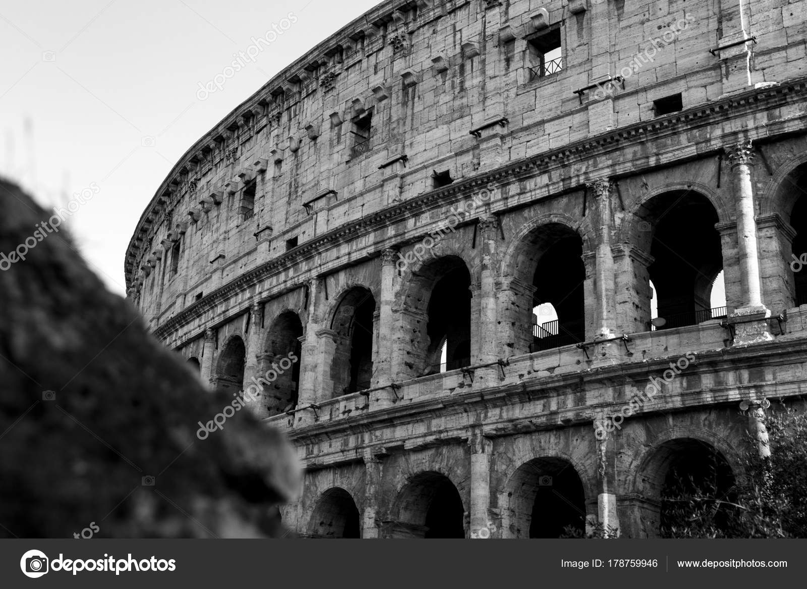 Black and white photo of the part of the wall of colosseum coliseum in rome italy at sunset stock image