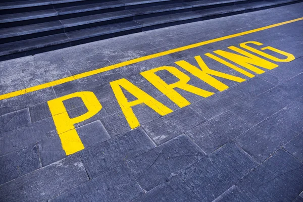 La palabra "aparcamiento" pintado de amarillo sobre asfalto gris — Foto de Stock