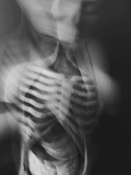 Abstract disease and disorder concept. Human body with bones and internal organs. Long exposure creative vertical black and white background. — Stock Photo, Image