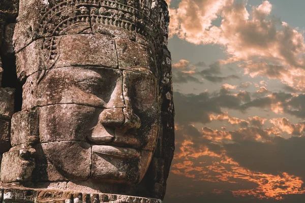 El templo Bayon-Khmer en Angkor Wat en Camboya. Atracción turística popular. Caras de piedra sonrientes en las torres del templo. Cielo dramático — Foto de Stock