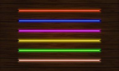 Bir dizi neon fırça. Koyu ağaç arkaplanındaki renkli ışık nesneleri kümesi