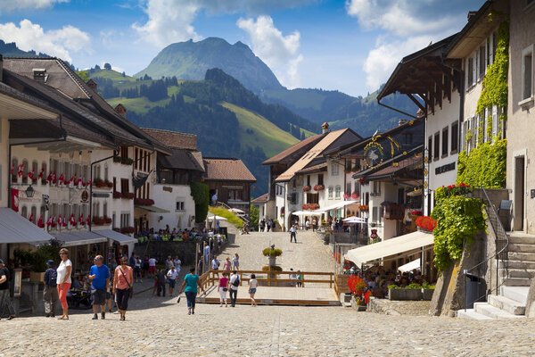 GRUYERES, CH, CIRCA JULY, 2016: View of the main street in the swiss town Gruyeres (Switzerland) on a beautiful summer day. Gruyere gives its name to the well-known Gruyere cheese