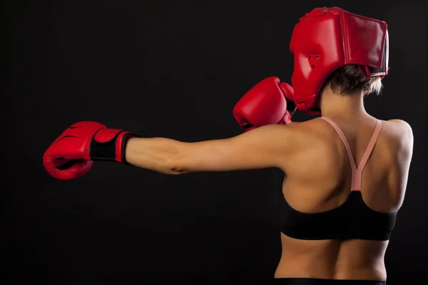 female boxer punching with red  boxing glove