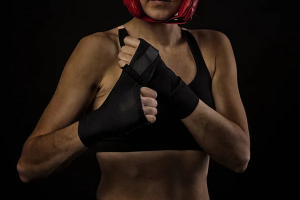 female boxer wrapping hands with boxing tape