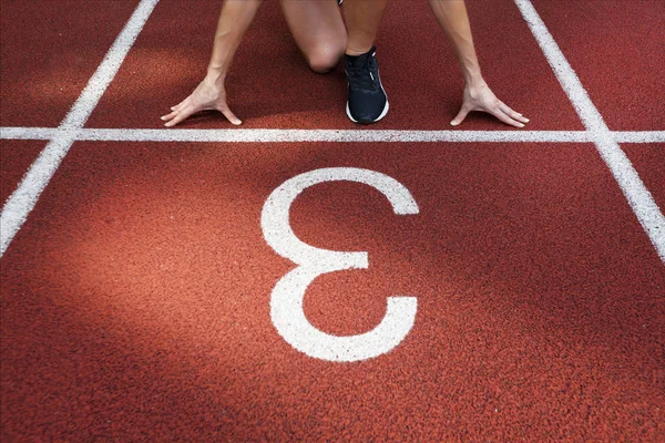 Female athlete running in pink runners on a track — Stock Photo, Image