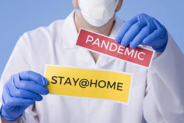 Coronavirus Karantinası, yazılı uyarı işareti beyaz önlüklü, eldivenli, yüzü tıbbi maskeli doktorların elinde. Karantina koronavirüsü salgını. Coronavirüs salgını.