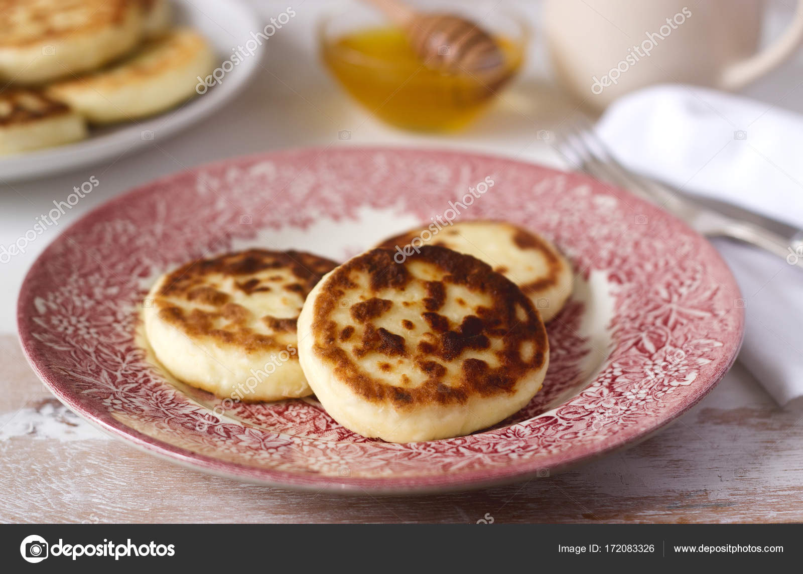 Cottage cheese pancakes, homemade syrniki with honey and sour cream