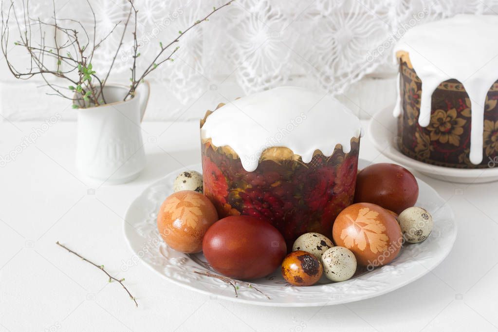 Easter still life with Easter cake kulich and painted eggs on a light background.