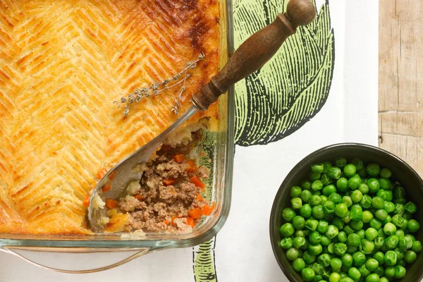 Shepherd\'s pie or cottage pie is a meat pie with a topping of mashed potato.
