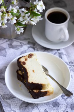 Lviv cheesecake, a traditional Ukrainian dessert with raisins, coated with chocolate icing. Selective focus. clipart