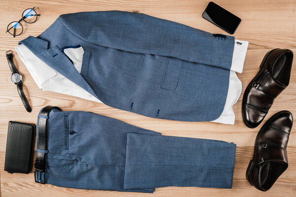 suit and accessories with smartphone on tabletop