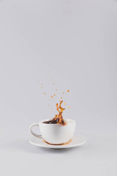 white coffee cup with splash