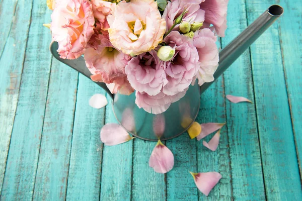 Beautiful flowers in watering can — Stock Photo, Image