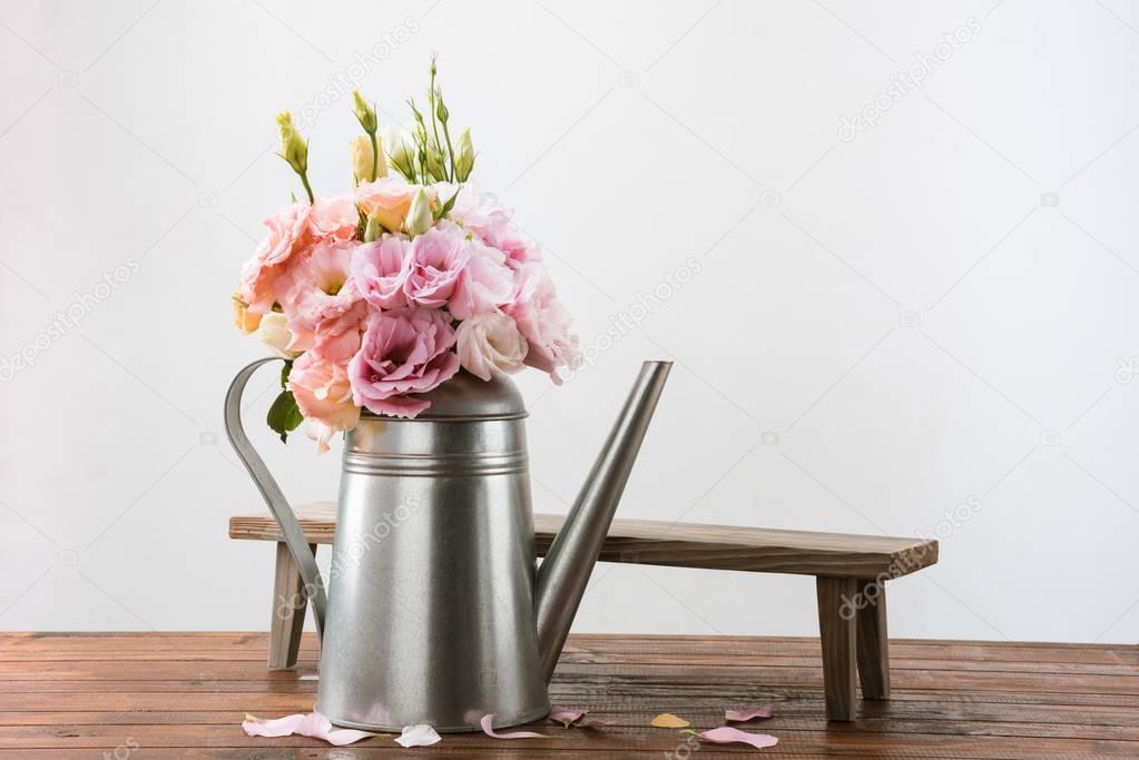Beautiful flowers in watering can