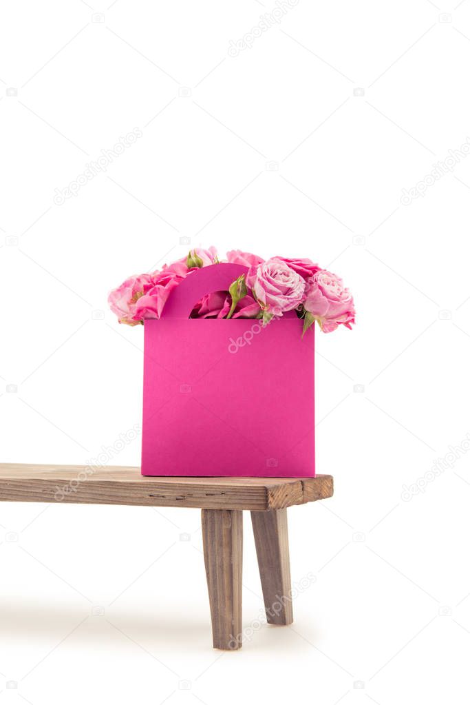 Roses in paper box on bench