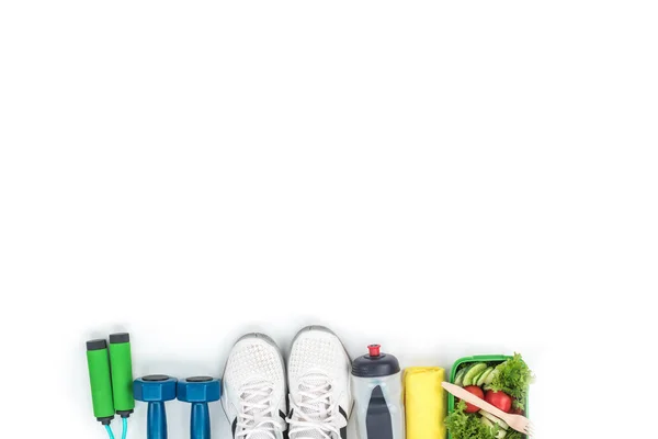 Fitness equipment and vegetable salad — Stock Photo, Image