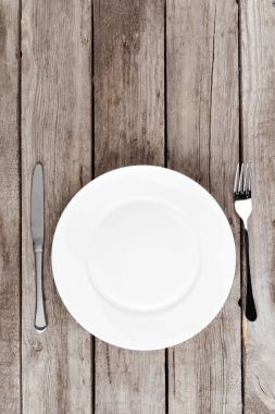 empty plate and silverware on table clipart