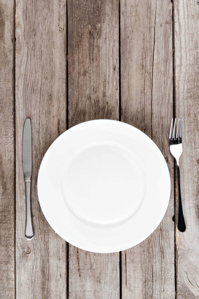 empty plate and silverware on table