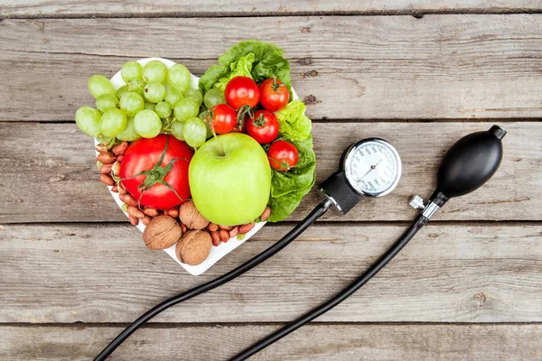 Vegetables, fruits and blood pressure gauge — Stock Photo, Image