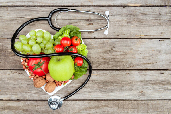 stethoscope, organic vegetables and fruits
