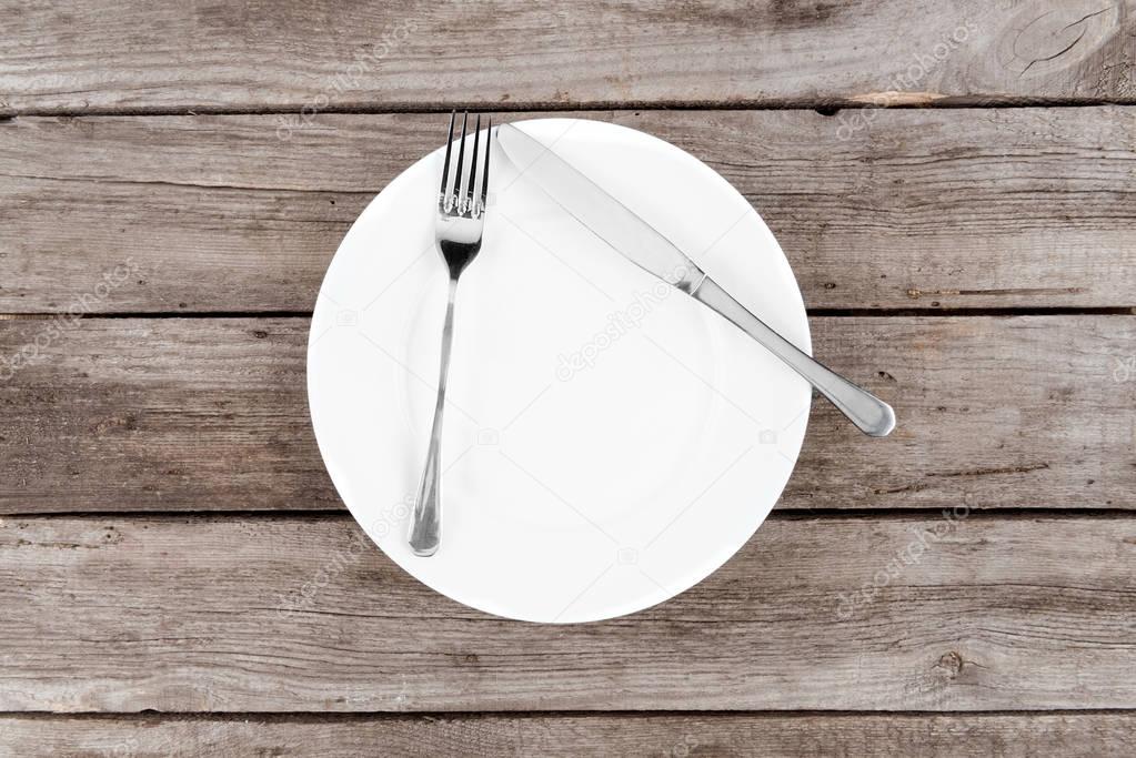 empty plate and silverware on table