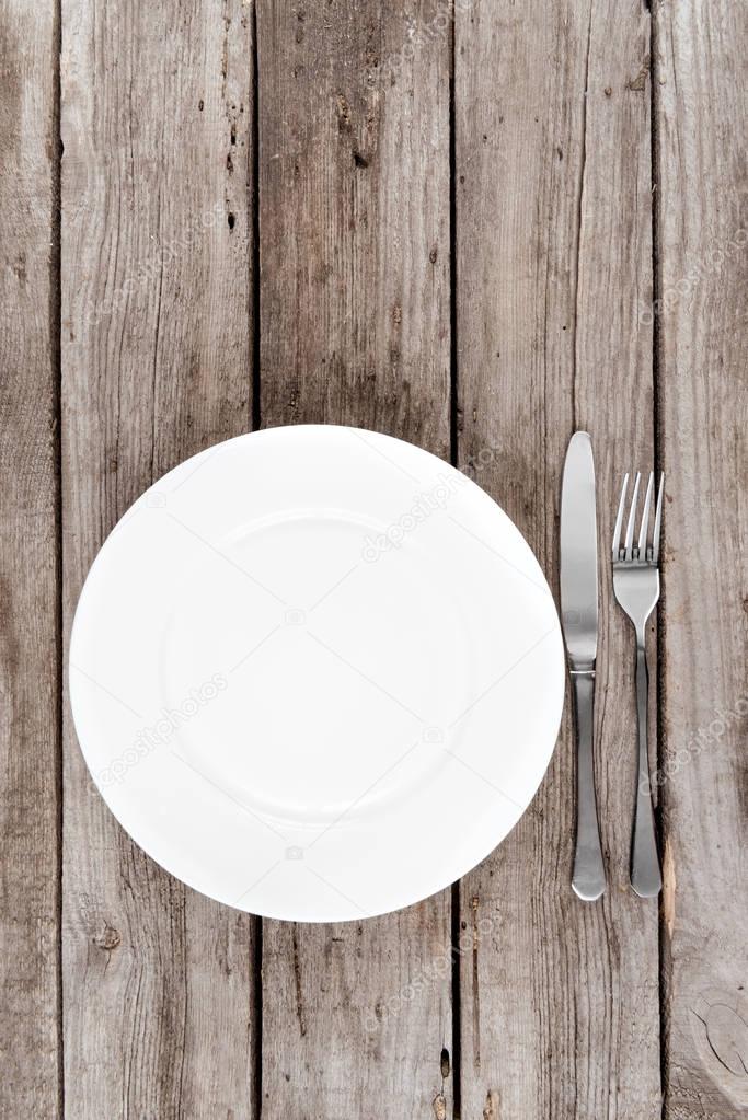 empty plate and silverware on table