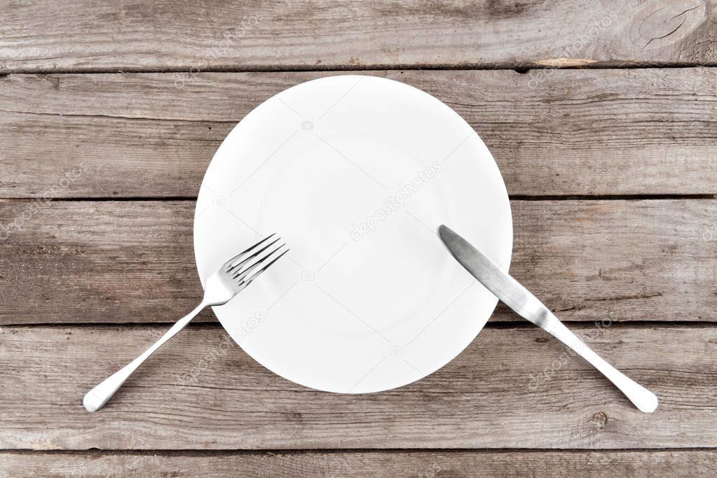 empty plate and silverware on table