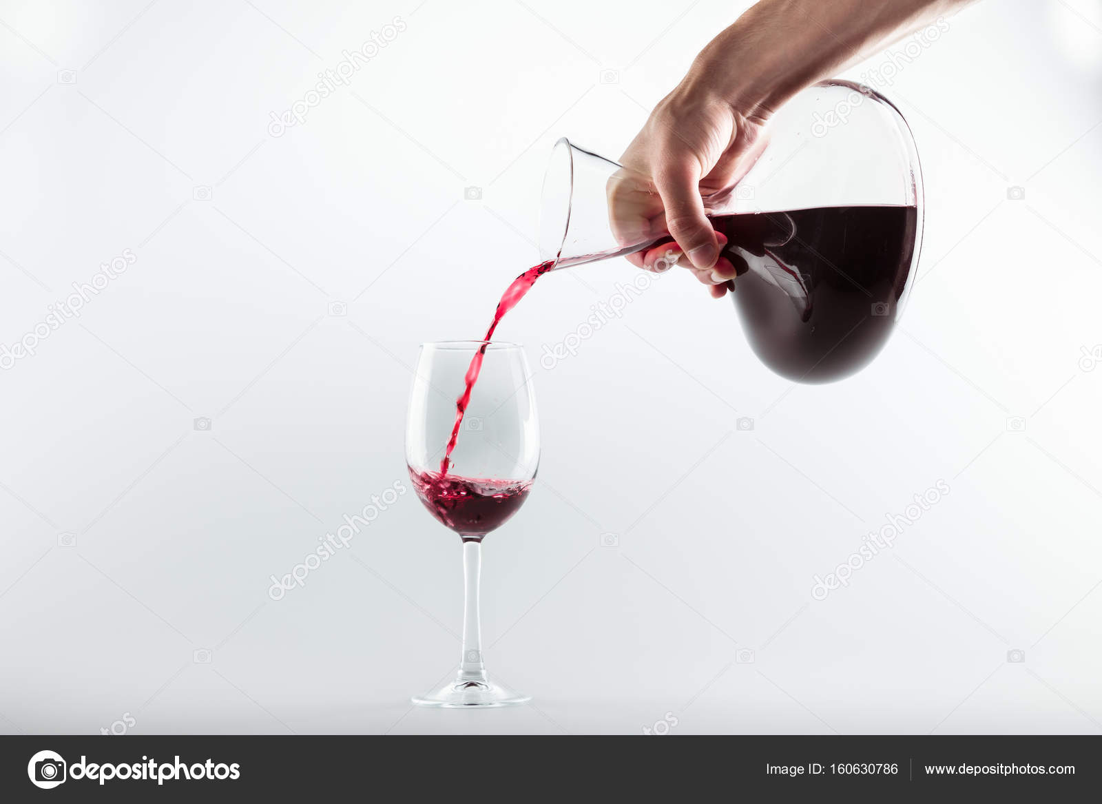 Hand Pouring Glass Of Wine