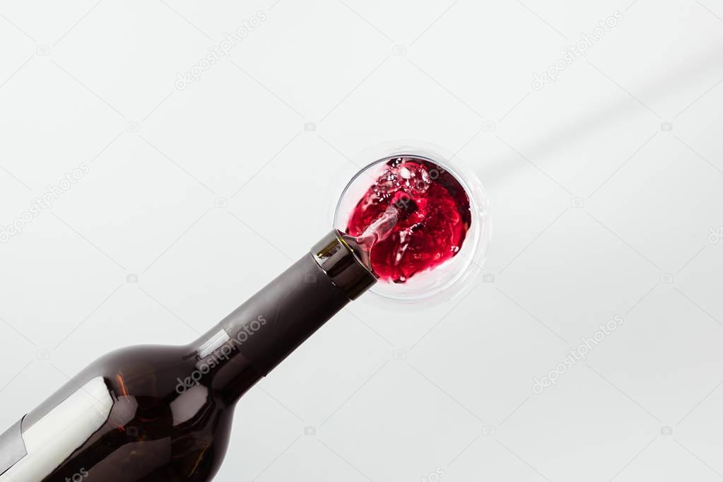 pouring wine from bottle in glass