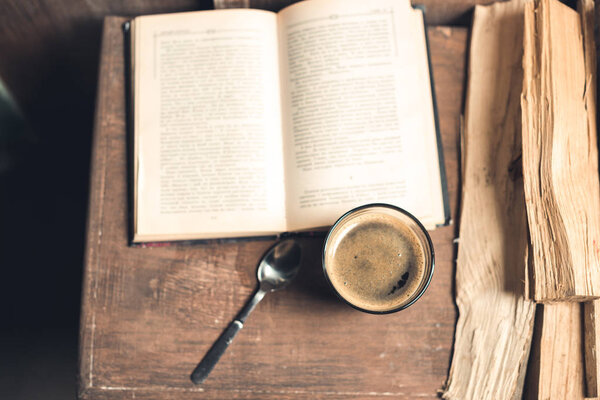 Glass of coffee, old book